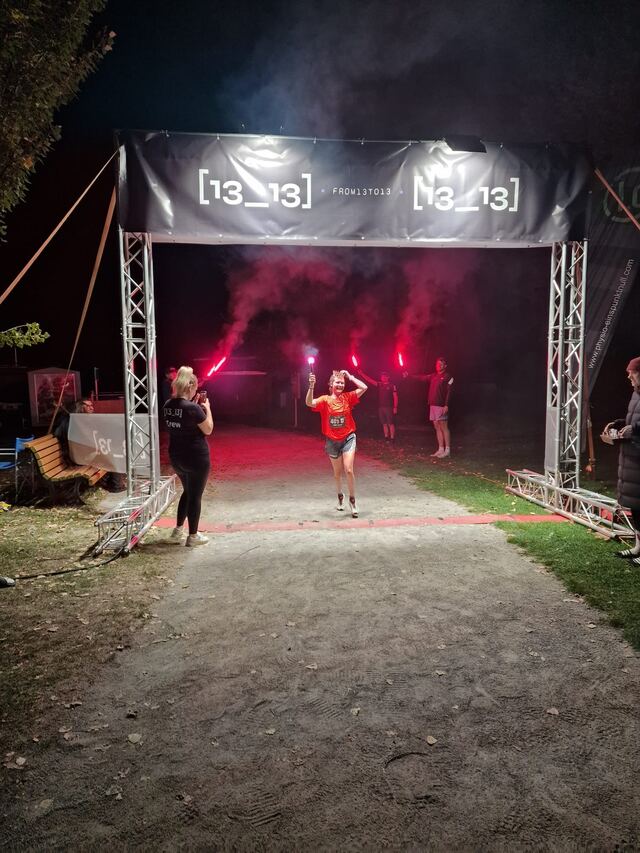 Läuferin jubelt im Zielbogen beim 24-Stunden-Lauf